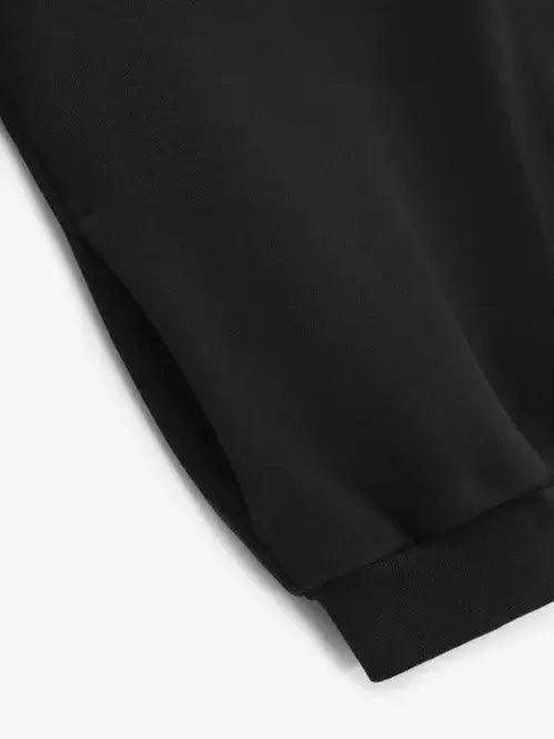 Essentials Fleece Crewneck Top close-up of cuffs and fabric detail in black.